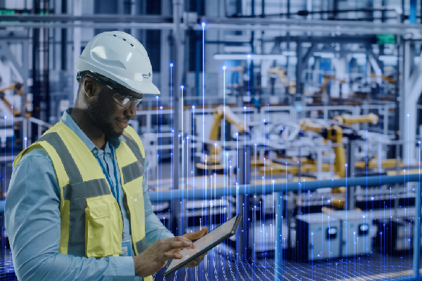 Graphic of transmission nodes overlaid in the background of an image of a Johnson Controls worker in a high visibility vest and safety helmet