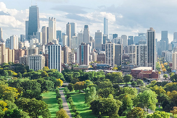 Cityscape across a lush park during a cloudy day