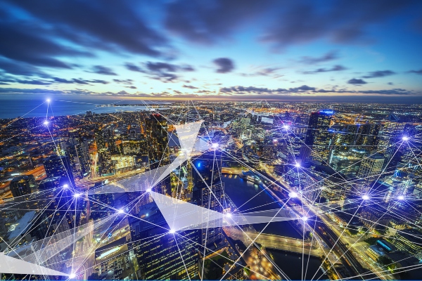 Ariel view of a city at dusk with graphics depicting interconnectivity