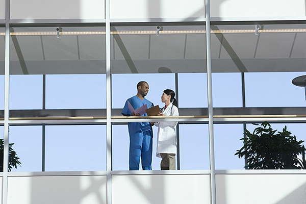 Two people standing in the hospital